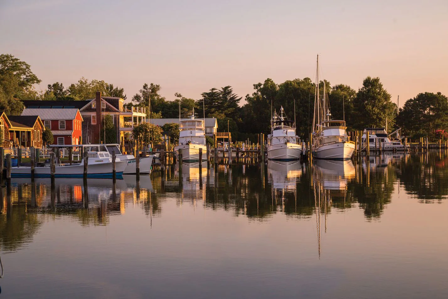 Dusk view of Oxford waterfront with moored sailboats and workboats