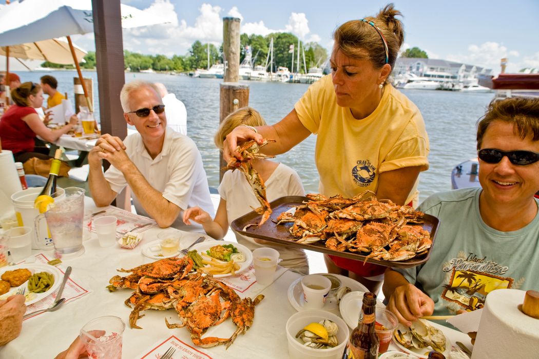 Woman serving steamed crabs