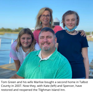 Tom Green and family on a dock; caption says they restored and reopened the Tilghman Island Inn