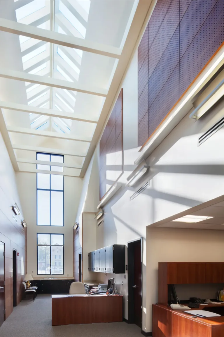 Office lobby with skylight, tall wall and wood reception desk