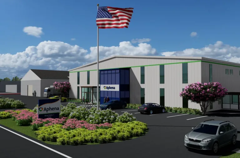 Modern office building with an American flag and an Aphena sign beside a landscaped entrance
