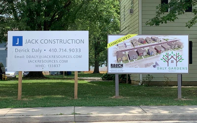 JACK CONSTRUCTION sign with contact details beside a second project sign