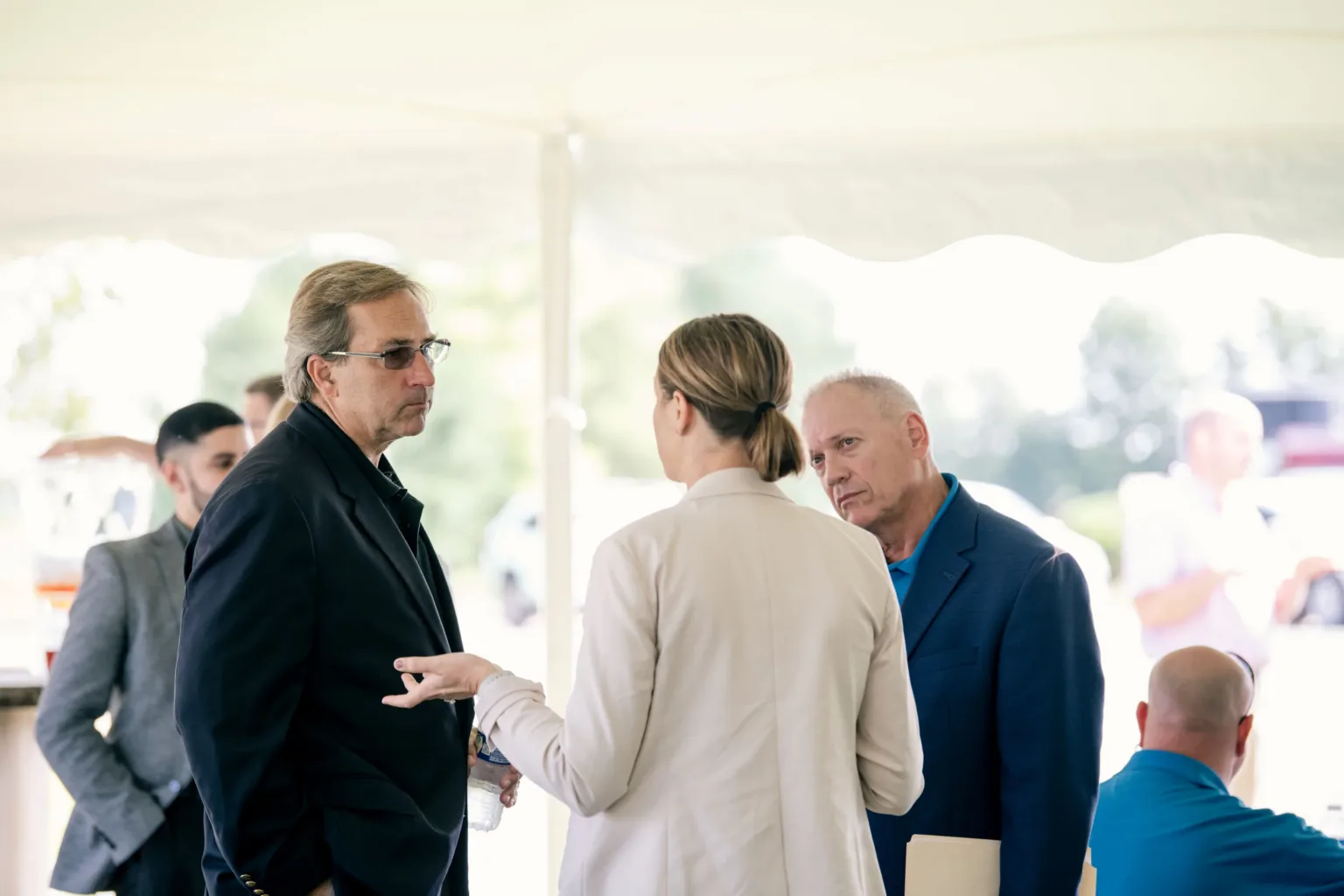 Guests chatting in a tent at an outdoor event