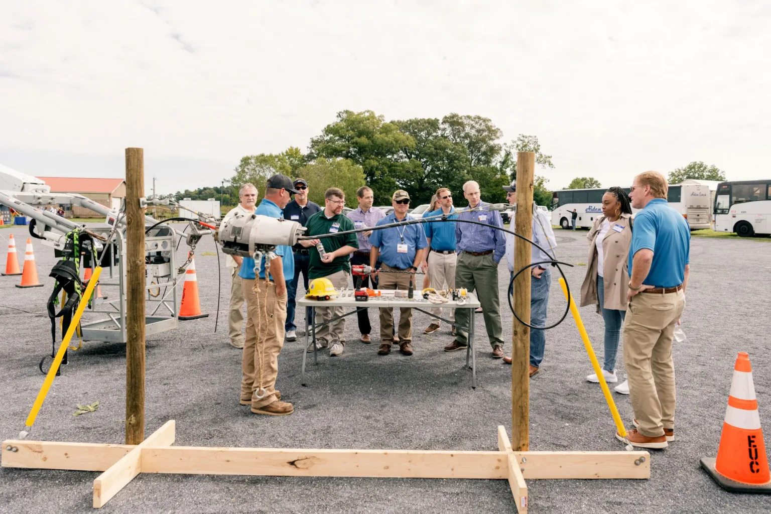Group gathered around a wooden frame at an outdoor site