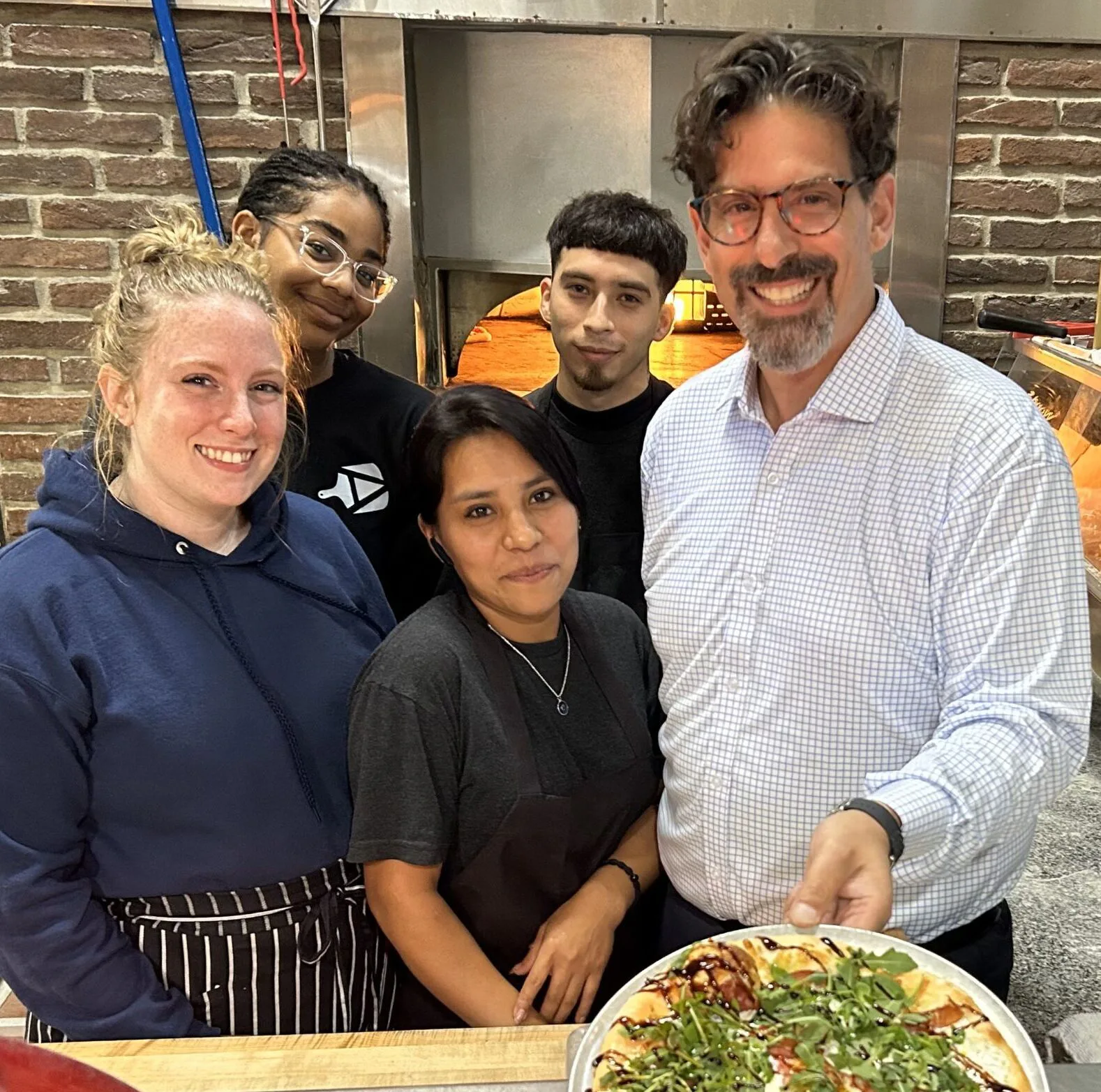 Ava’s Pizzeria & Wine Bar staff in St. Michaels gather in honor of the restaurant’s 15th anniversary, with the Chef’s Favorite pizza, shown, offered at a special price this October of $10.19 in recognition of the day the restaurant opened. Pictured from the left are Danella Gilligan, Makia Morton, Celina Perez Garcia, Edwin Martinez, and Chris Agharabi. Reservations and more are at www.avaspizzeria.com.