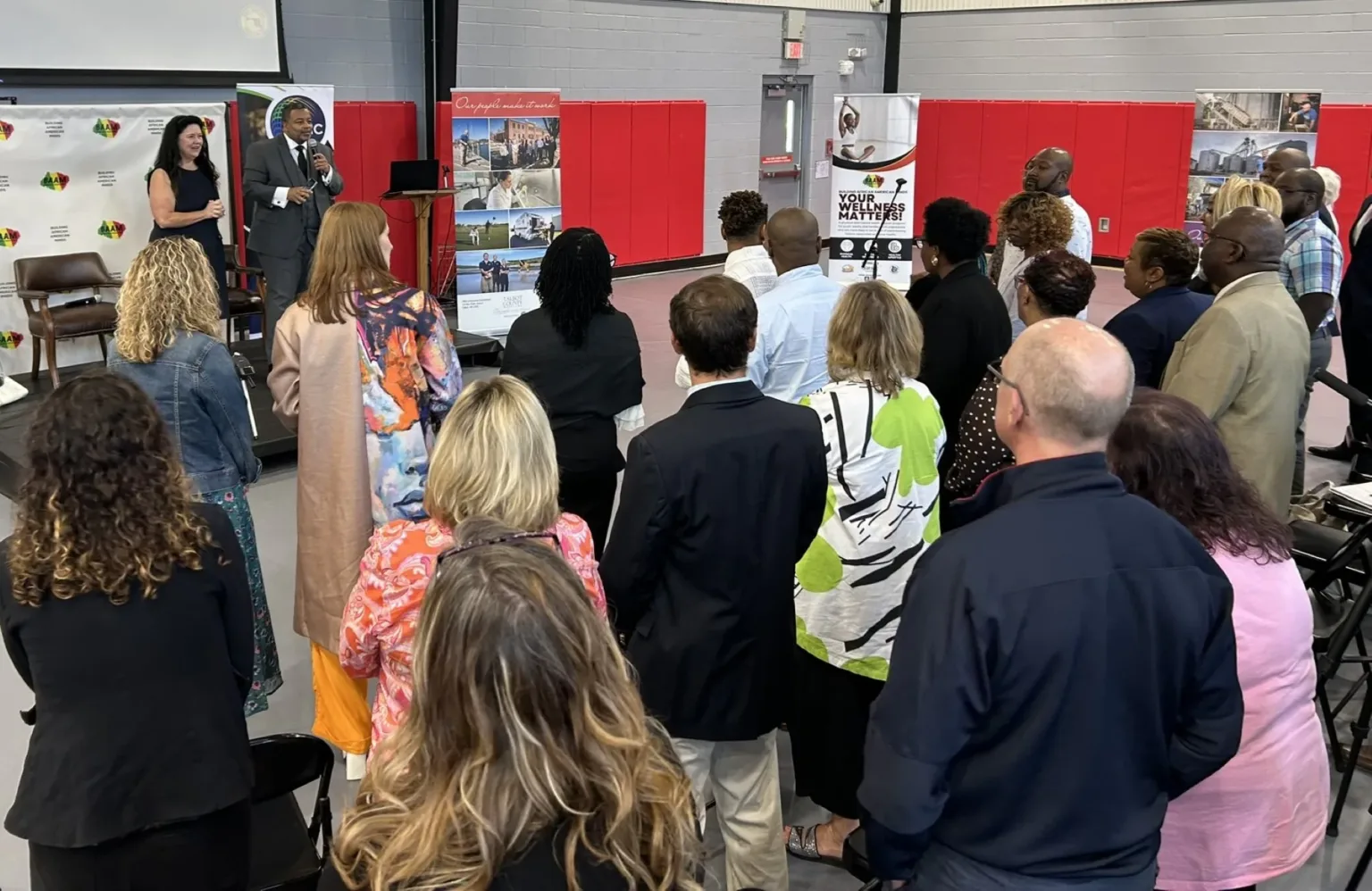 Attendees gathered in front of a presentation area at a conference