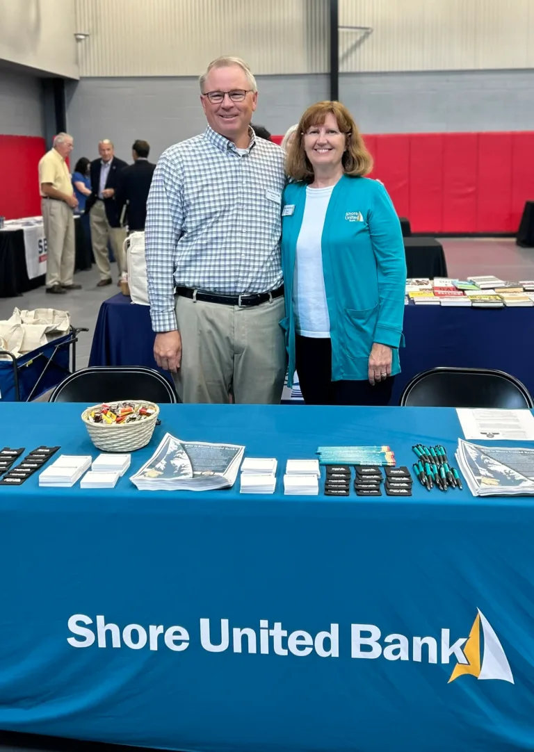 Shore United Bank table with two smiling people at a conference hall