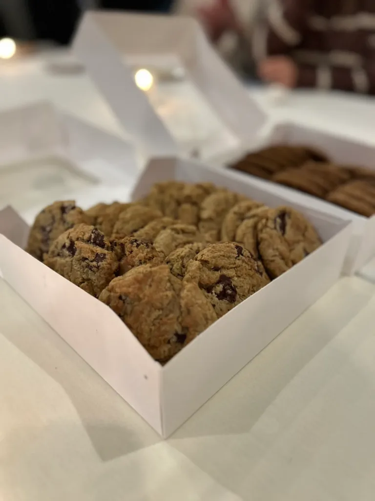 Two boxes of chocolate chip cookies on a white table