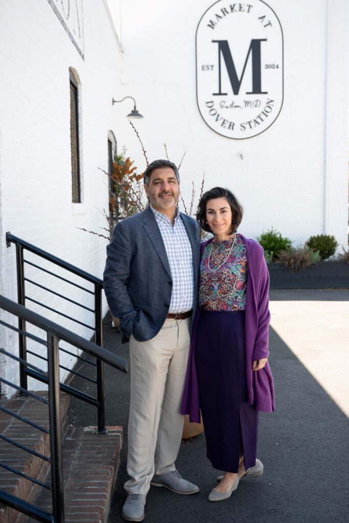 Sevan and Keri Topjian stand in front of The Market at Dover Station, in shade