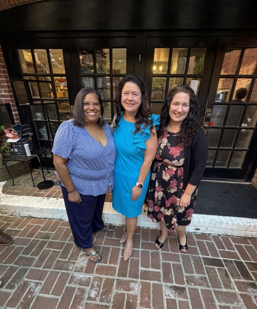Cassandra Vanhooser with staff members Candace Harris and Kristen Goller