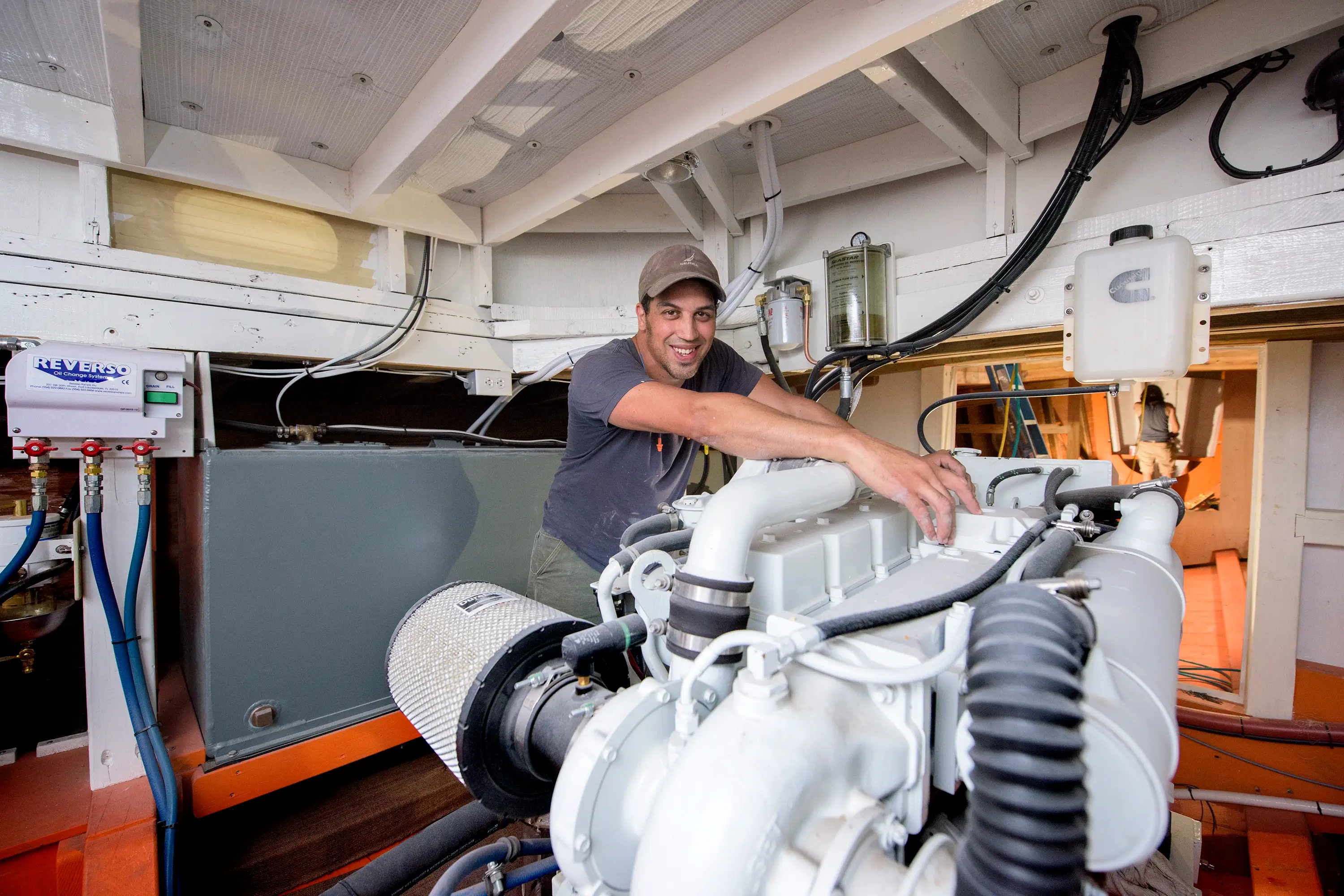 A man leaning against a boat engine