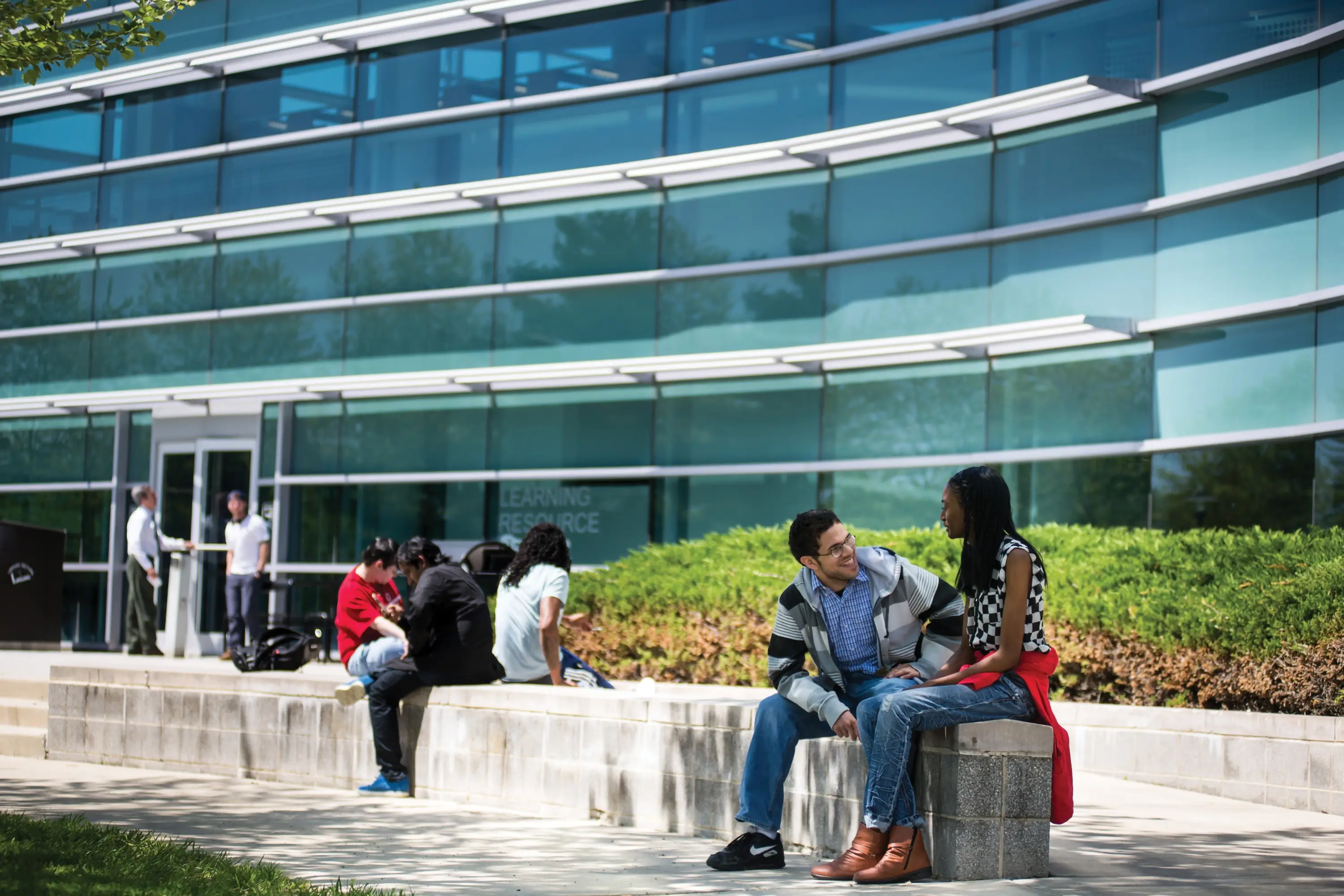 Students sitting outside of a building