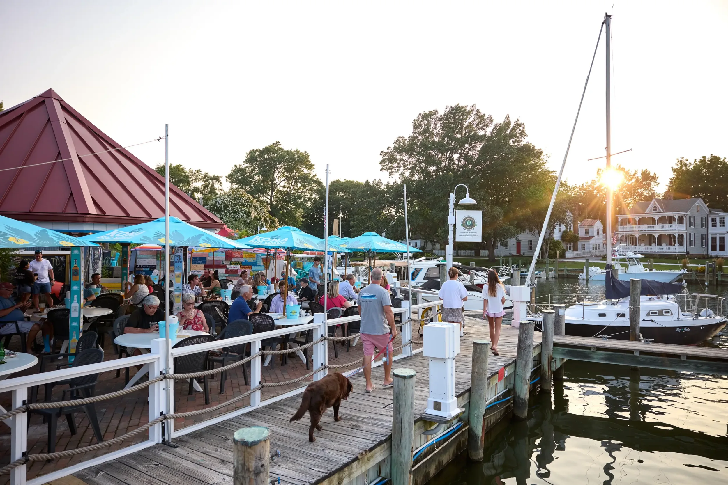People eating at a restaurant by the marina