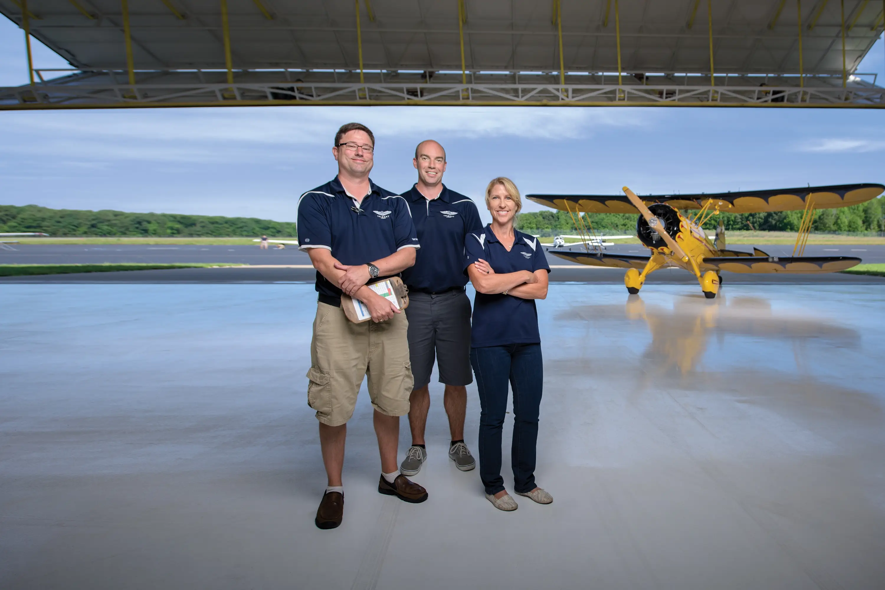 The Trident crew standing in a hangar